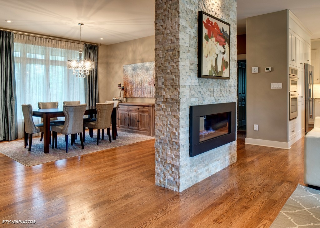 Double-sided stacked-stone fireplace feature by Canadian Masonry Services, Ottawa